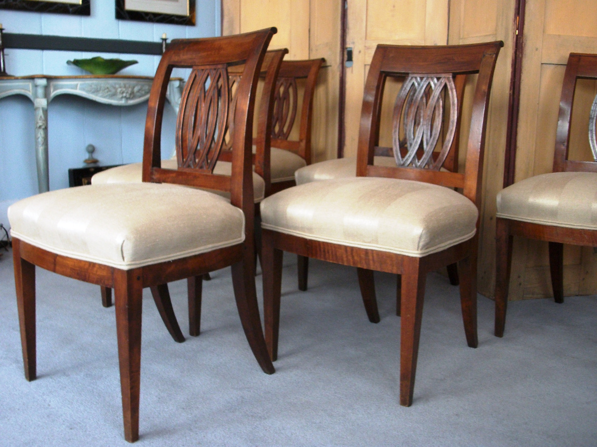  	Italian walnut chairs with sabre back legs and decorative pierced back splat. 